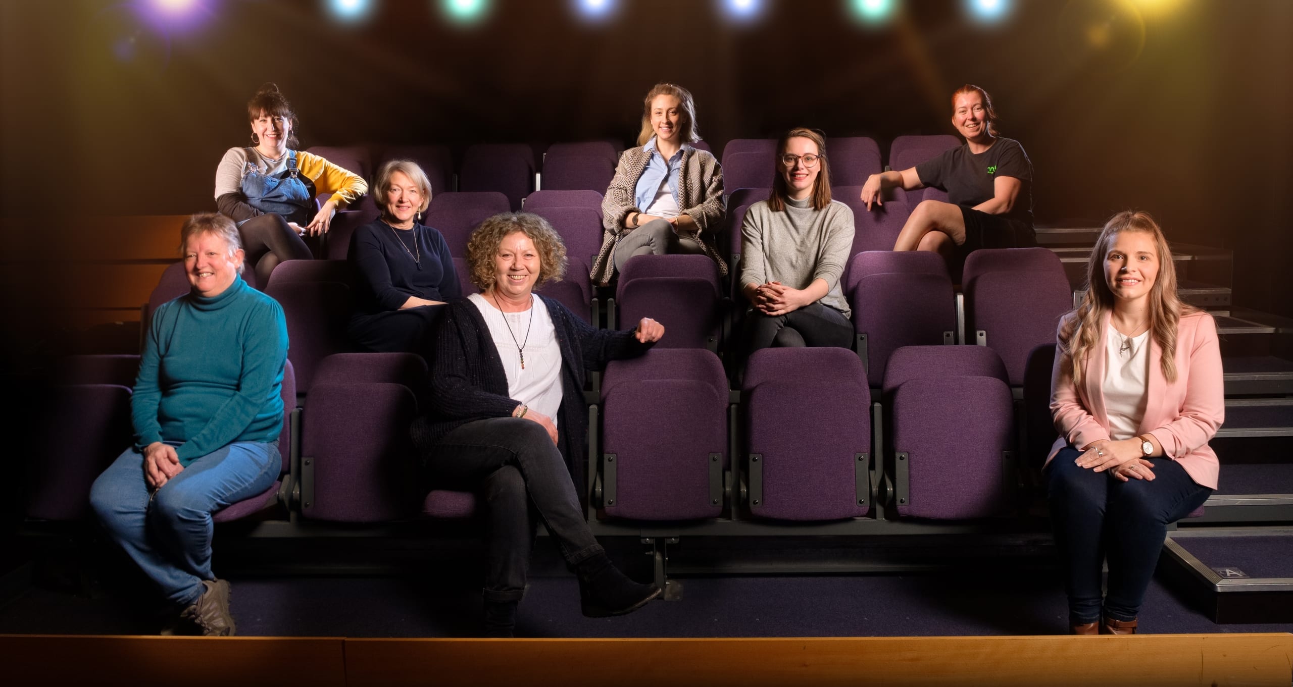 M6 staff members sat on purple foldable theatre seats